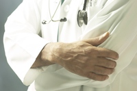 Man in white lab coat illustrating experimenter